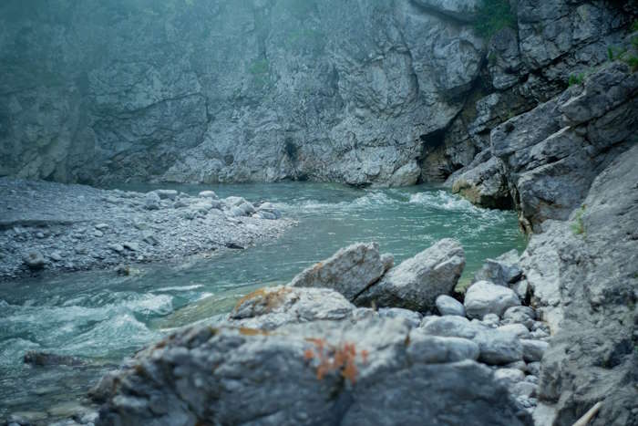 Felsiger Flusslauf in einer Schlucht mit unscharfem, nebeligem Effekt, der an die visuellen Symptome einer Augenmigräne erinnert.